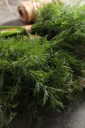 Photo of Fresh dill on grey table, closeup view