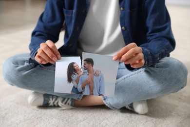 Woman ripping photo on floor, closeup. Divorce concept
