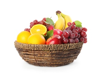 Photo of Wicker basket with different fruits on white background