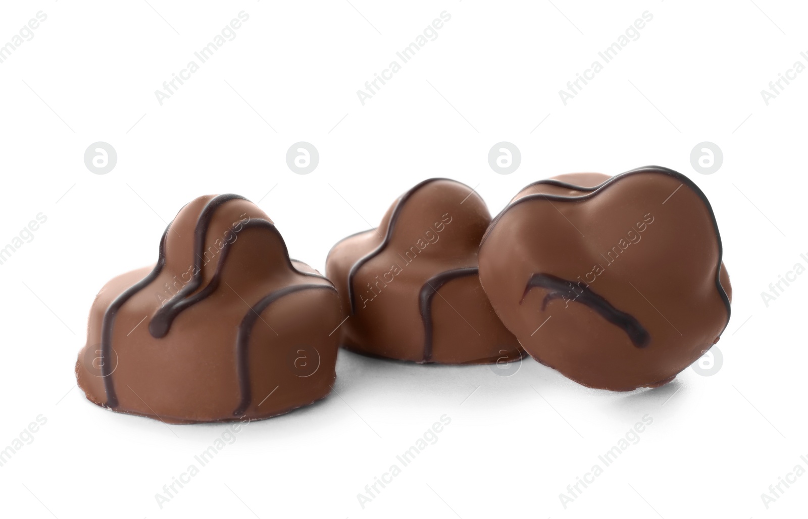 Photo of Delicious milk chocolate candies isolated on white