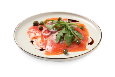 Delicious salmon carpaccio with arugula, capers and onion on white background