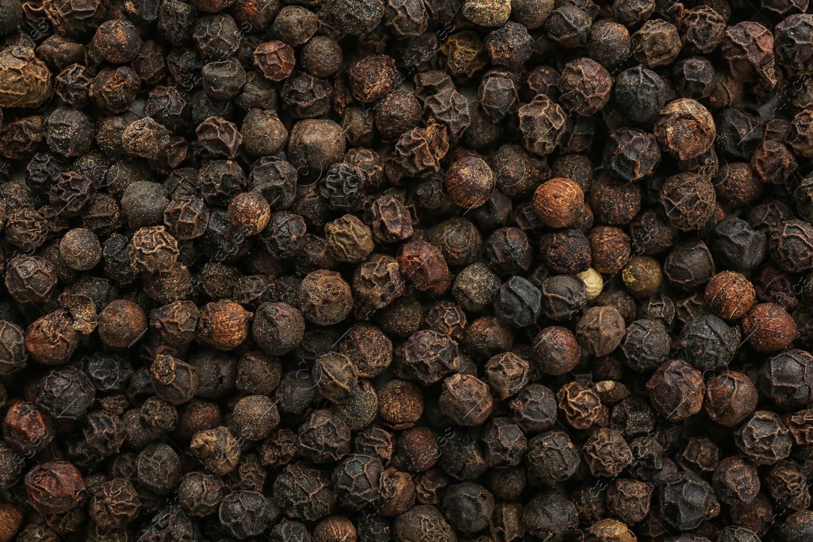 Photo of Black pepper corns as background. Natural spice