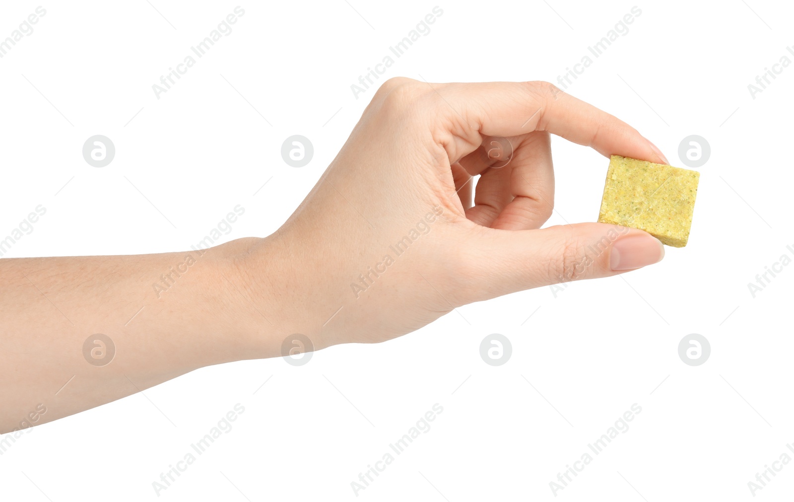 Photo of Woman holding bouillon cube on white background, closeup
