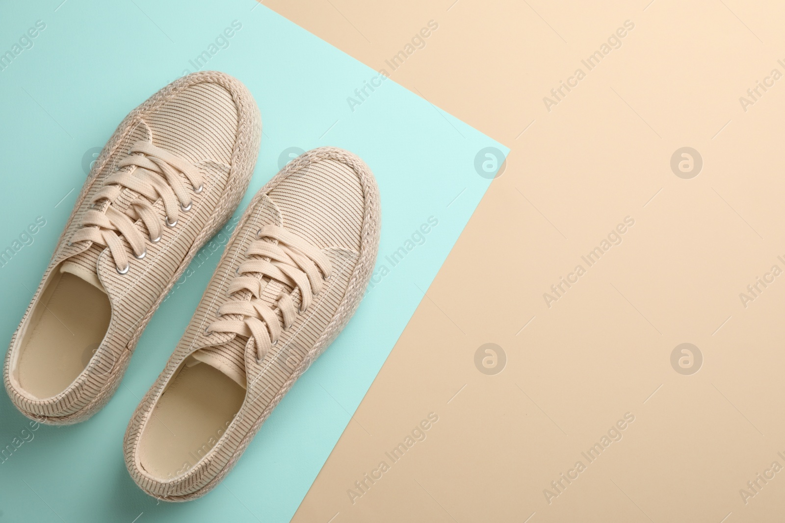 Photo of Pair of stylish comfortable shoes on color background, flat lay. Space for text