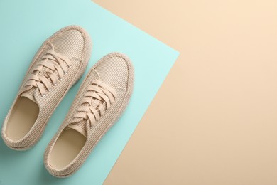 Pair of stylish comfortable shoes on color background, flat lay. Space for text