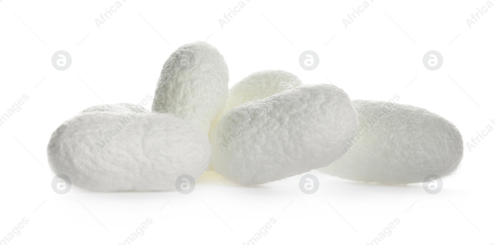 Photo of Pile of natural silkworm cocoons on white background