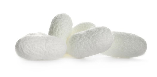 Pile of natural silkworm cocoons on white background