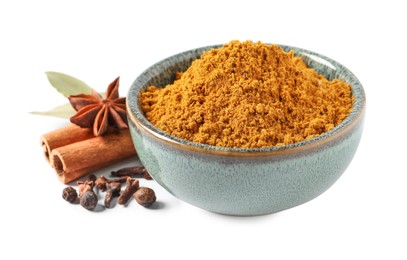 Photo of Dry curry powder in bowl, clove buds, anise star and cinnamon sticks isolated on white