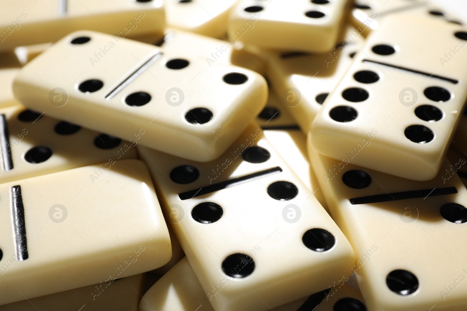 Photo of Set of classic domino tiles as background, closeup