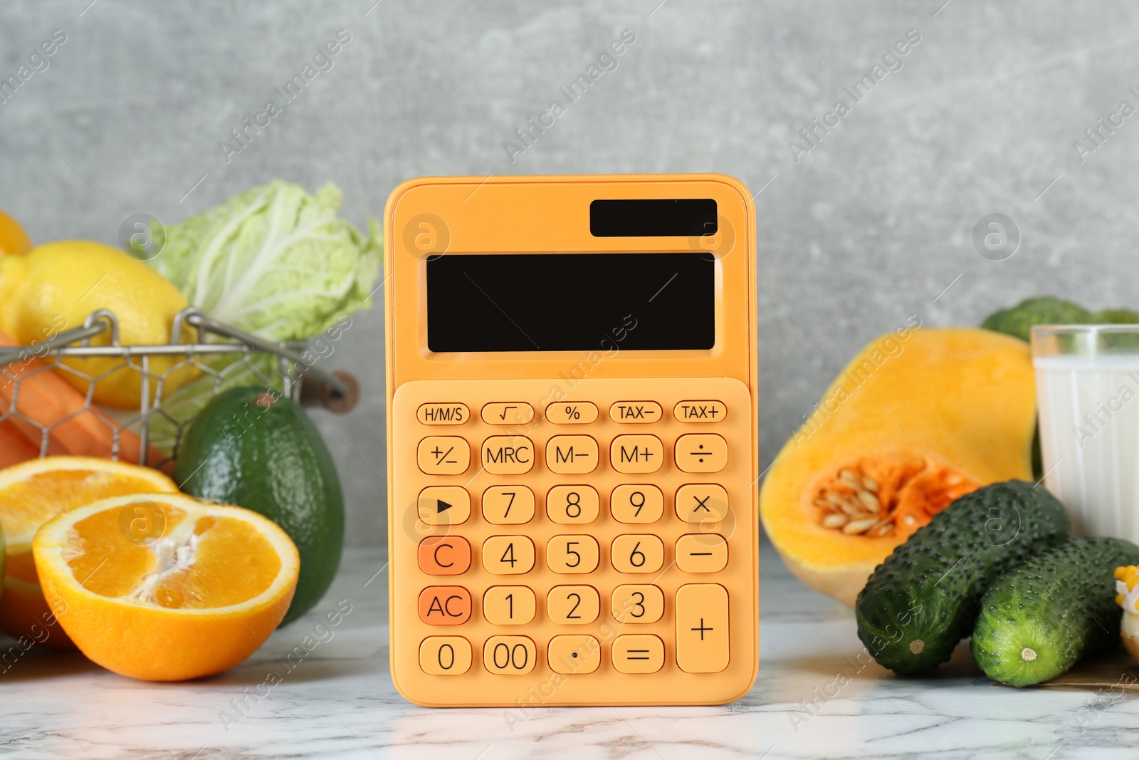 Photo of Calculator and food products on white marble table. Weight loss concept