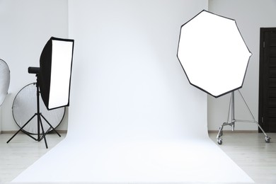 Photo of Interior of modern photo studio with professional lighting equipment