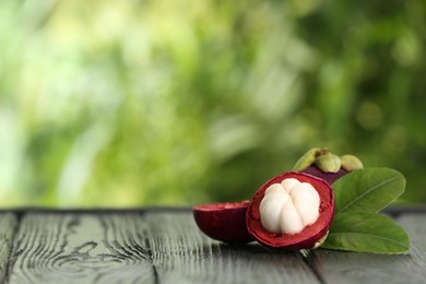 Photo of Open mangosteen fruit outdoors, space for text