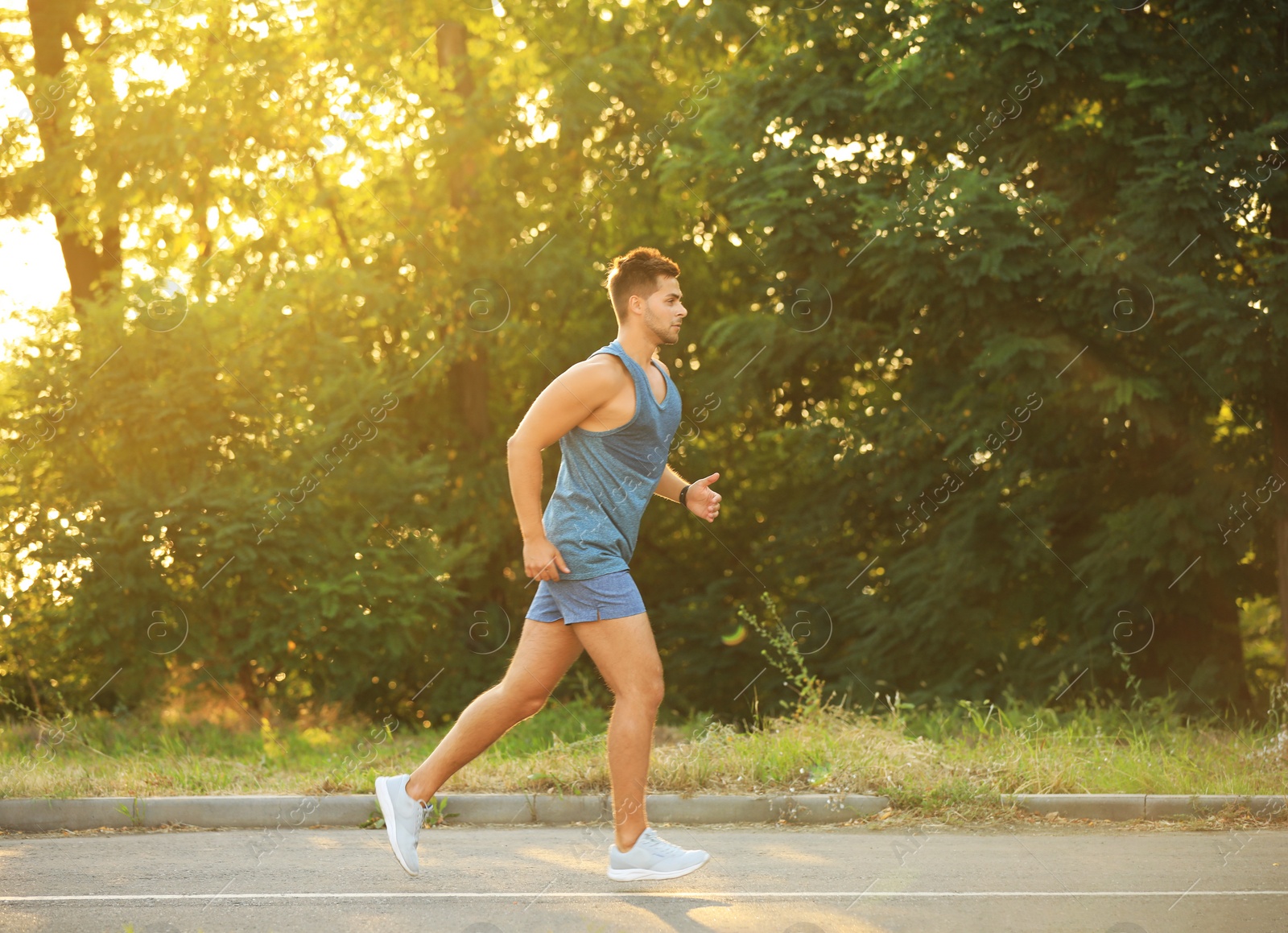 Photo of Young man running in park on sunny day