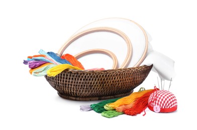 Photo of Colorful threads and different embroidery accessories on white background