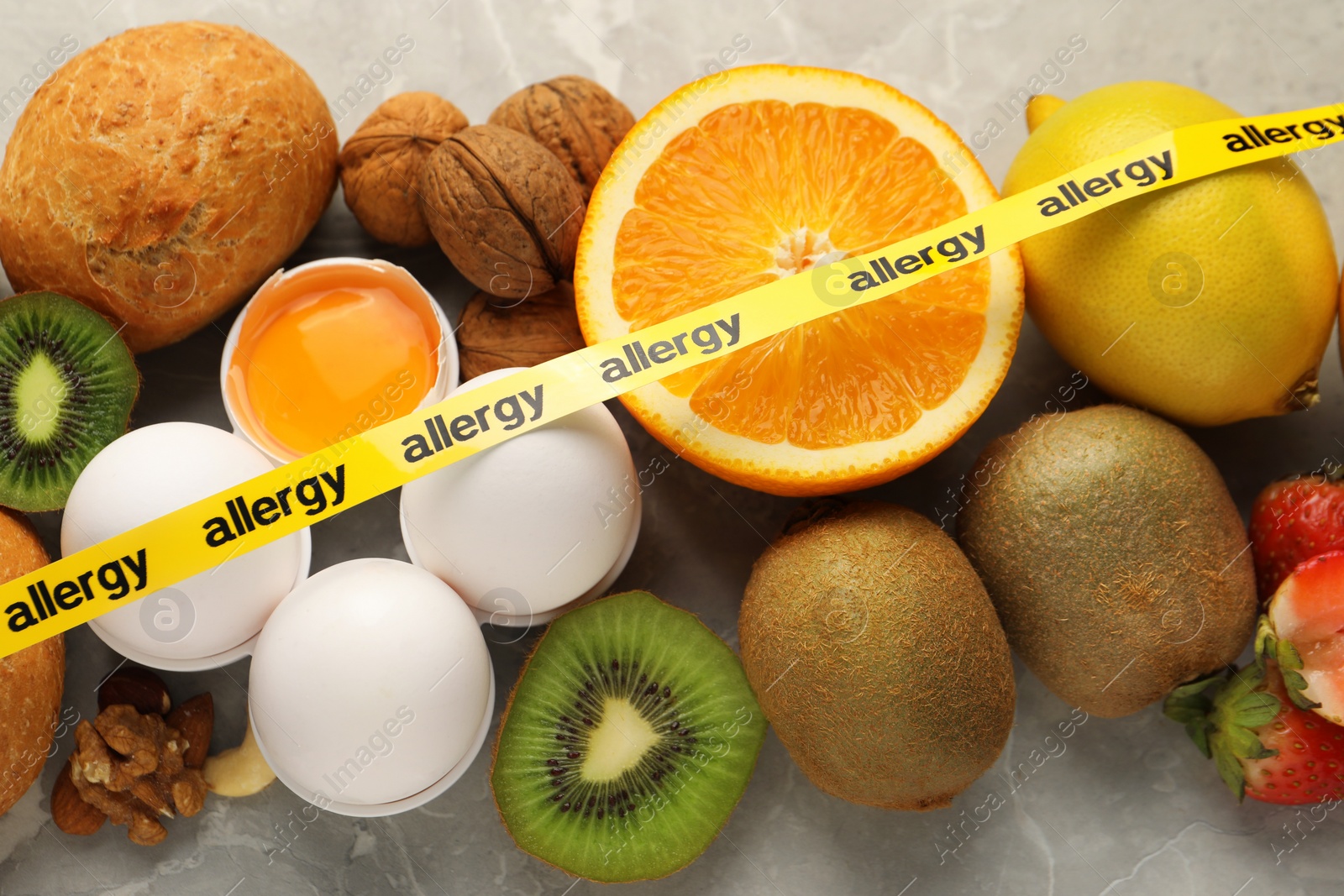 Photo of Allergenic food. Different fresh products with tape on table, top view