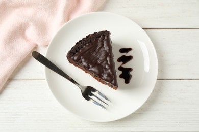 Photo of Tasty chocolate cake served on white wooden table, flat lay
