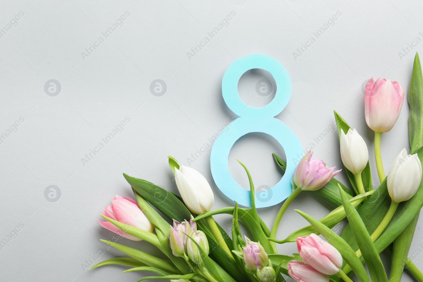 Photo of 8 March card design with tulips and space for text on light grey background, flat lay. International Women's Day