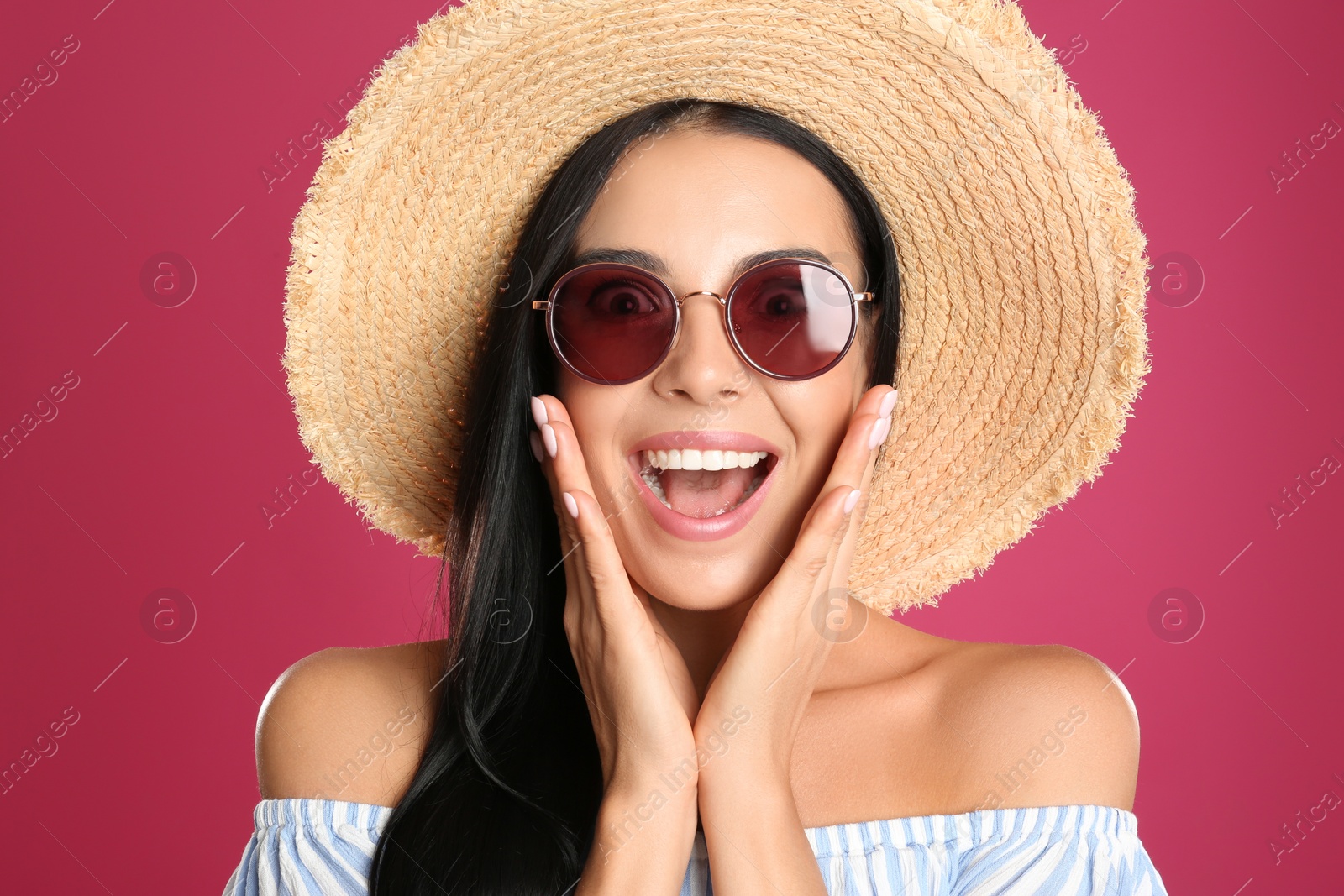 Photo of Excited woman wearing sunglasses on pink background