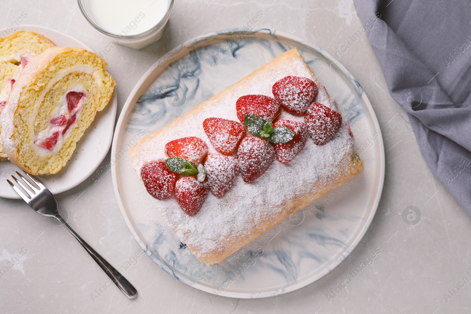 Photo of Delicious cake roll with strawberries and milk on light gray table, flat lay