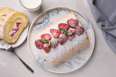 Photo of Delicious cake roll with strawberries and milk on light gray table, flat lay