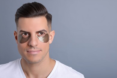 Photo of Man with dark under eye patches on grey background. Space for text