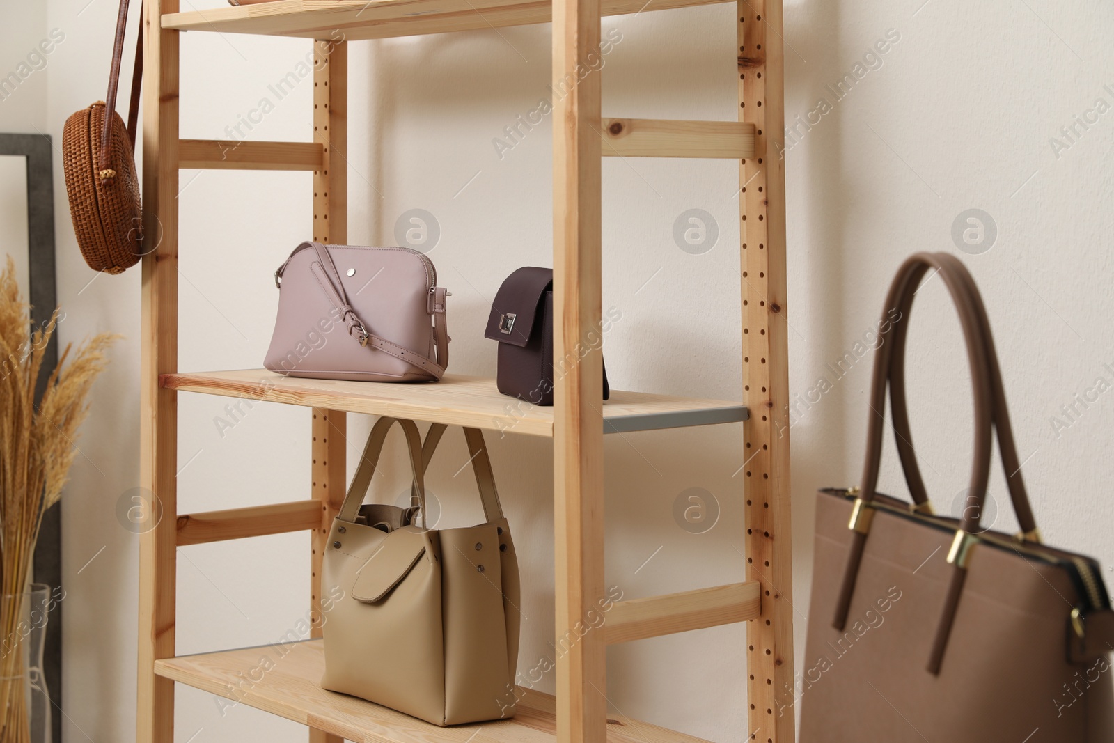 Photo of Stylish woman's bags on shelves in boutique