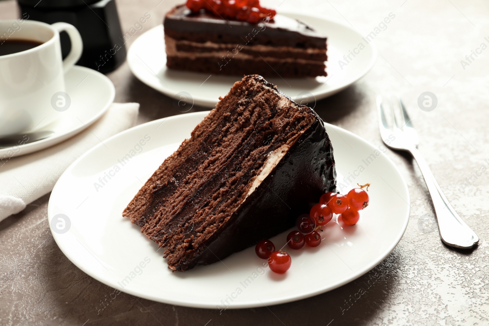 Photo of Slice of tasty chocolate cake with berries served on table