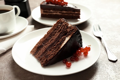 Slice of tasty chocolate cake with berries served on table