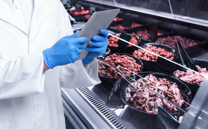 Image of Food quality control specialist examining seafood in supermarket, closeup