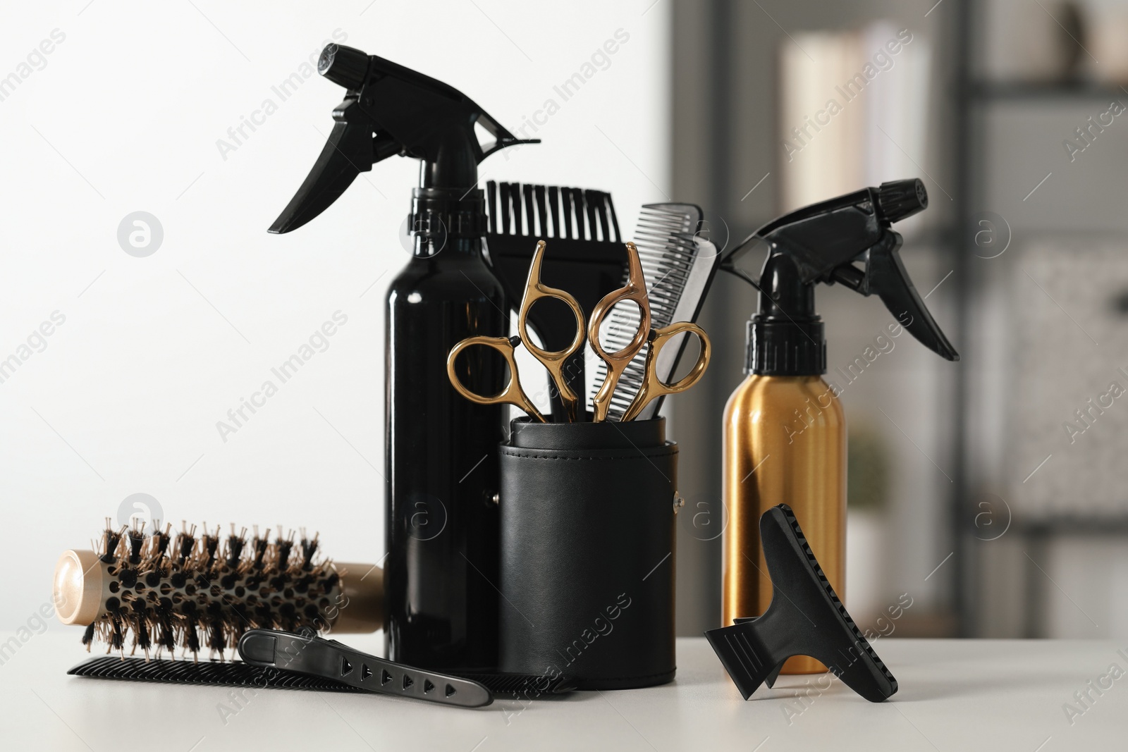 Photo of Set of hairdresser tools on table in salon