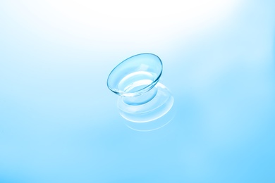 Photo of Contact lens on color glass background