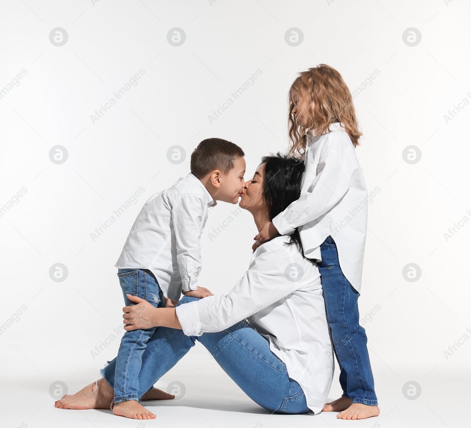 Photo of Little children with their mother on white background