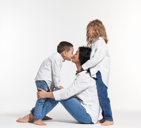 Little children with their mother on white background