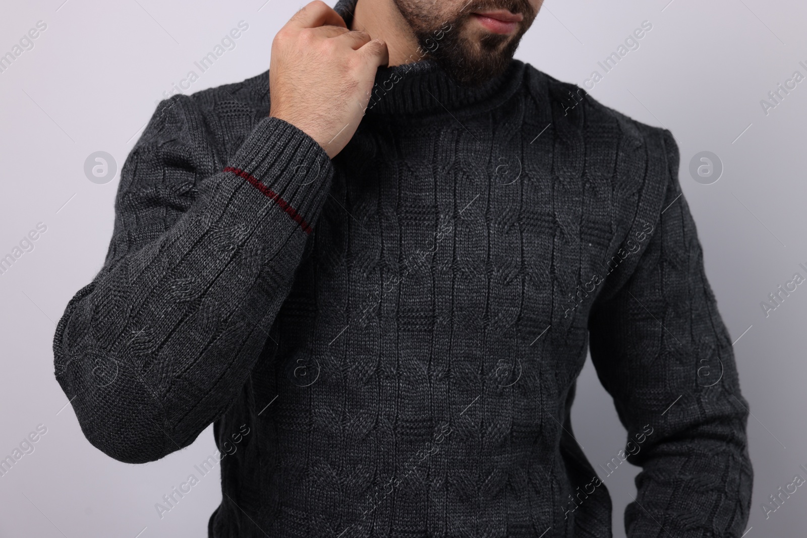 Photo of Man in stylish sweater on white background, closeup