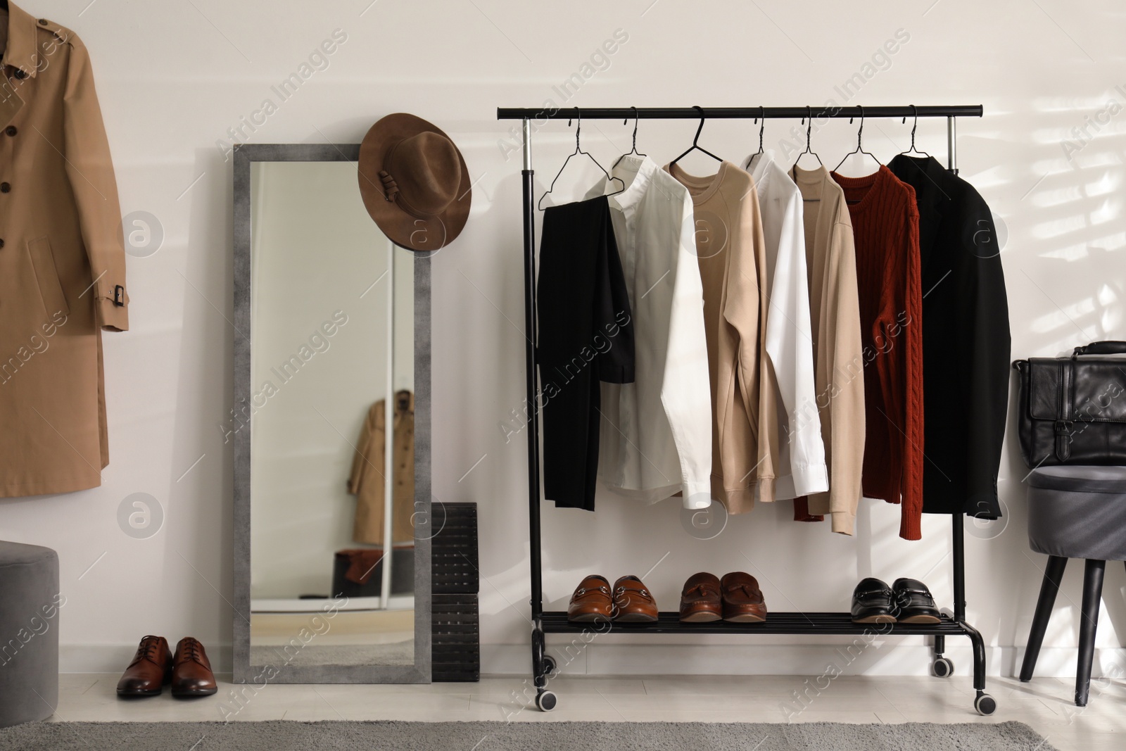 Photo of Dressing room interior with clothing rack and mirror