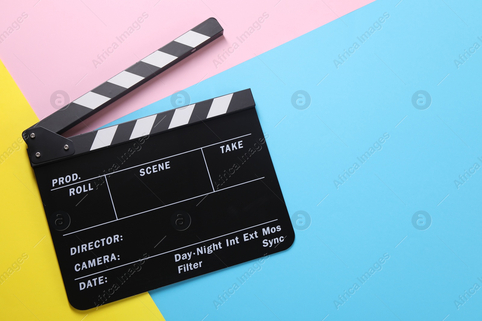 Photo of Clapperboard on color background, top view. Space for text