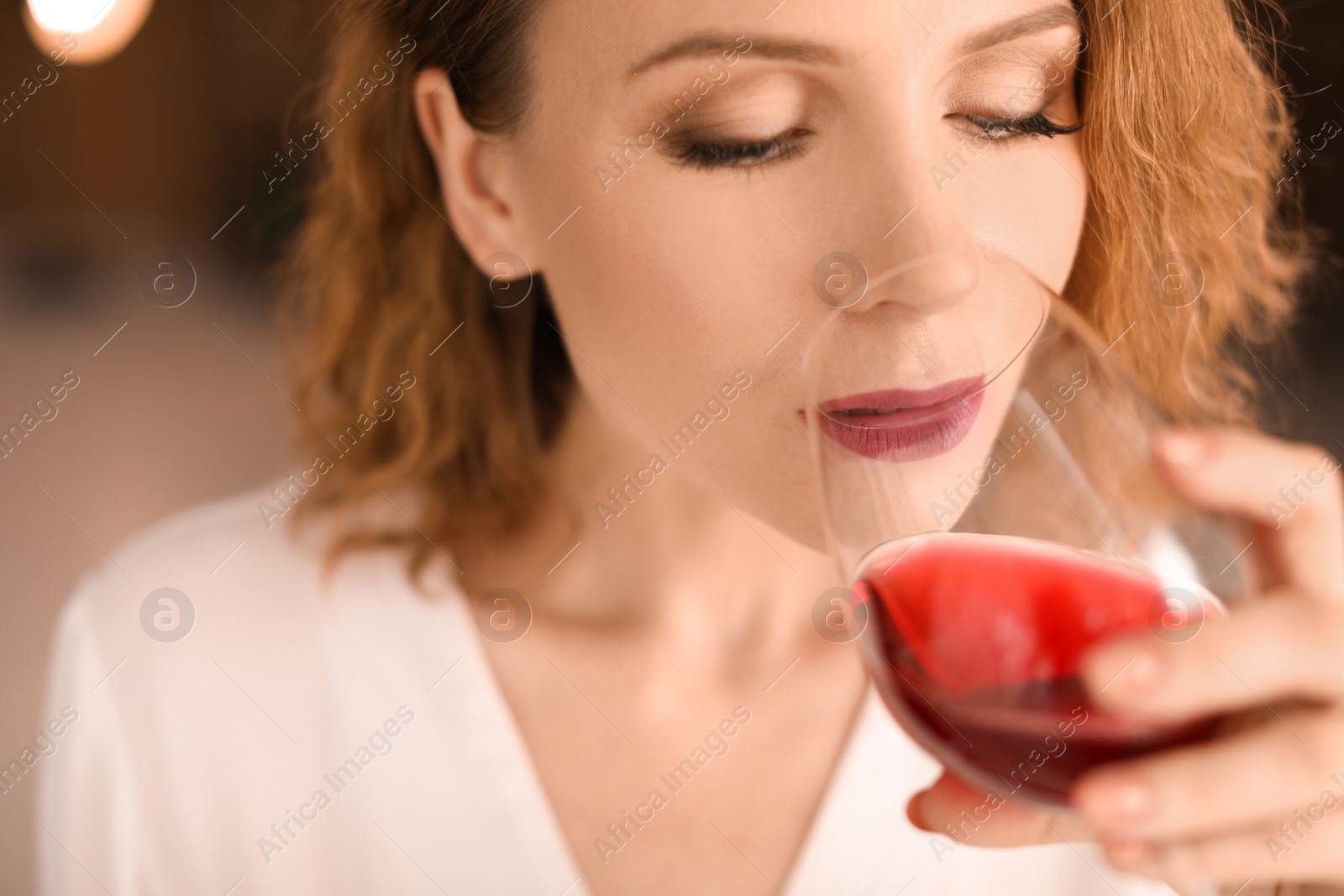 Photo of Woman with glass of delicious wine indoors