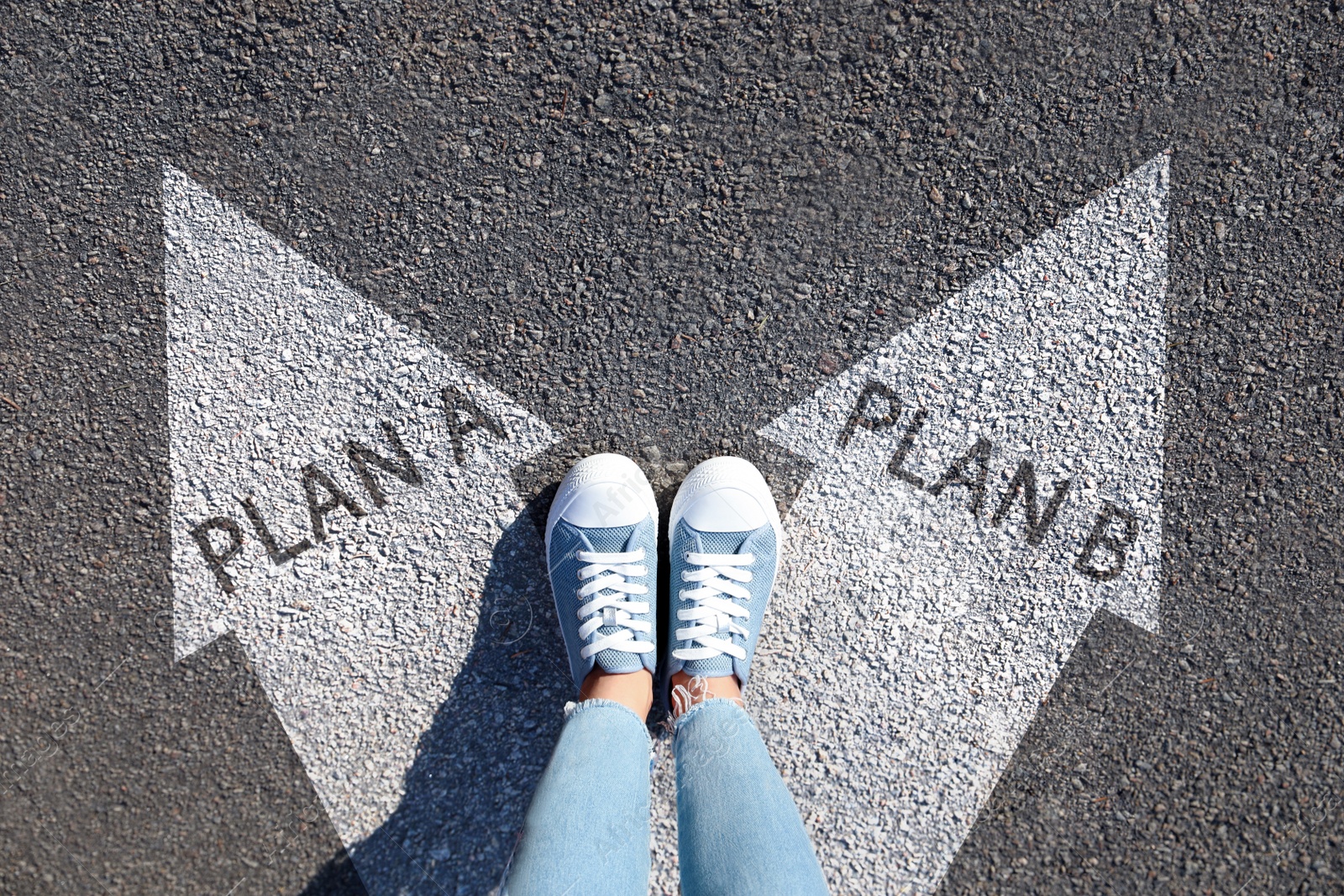 Image of Choosing between Plan A and Plan B. Woman near arrows on road, above view