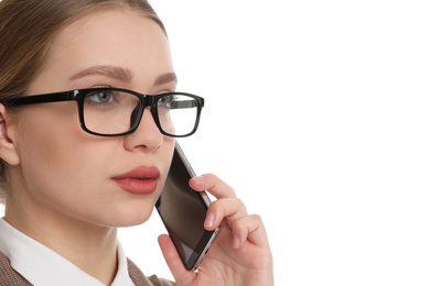 Young businesswoman talking on mobile phone against white background