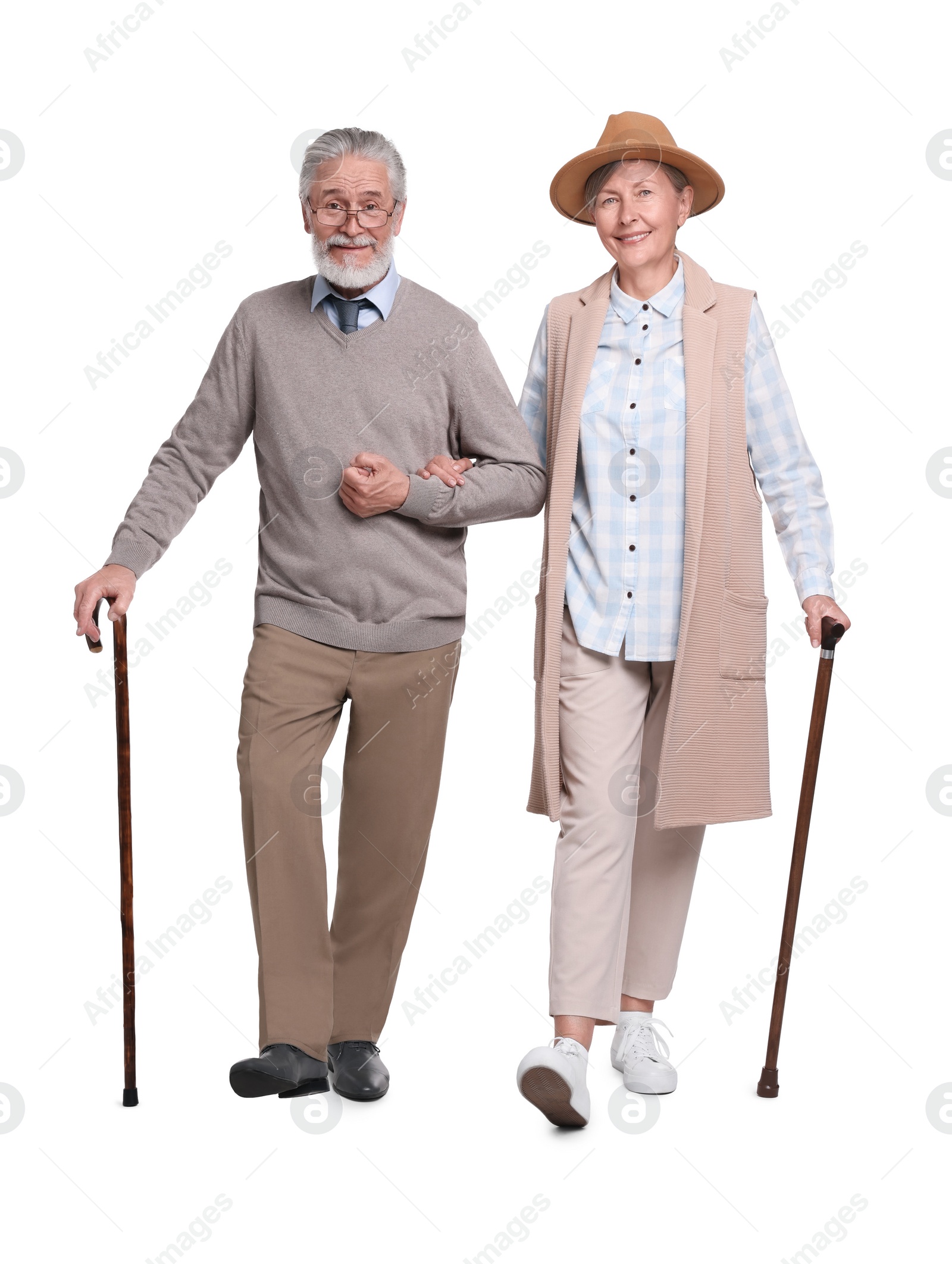 Photo of Senior man and woman with walking canes on white background