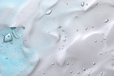 Transparent cleansing gel on light grey background, closeup. Cosmetic product