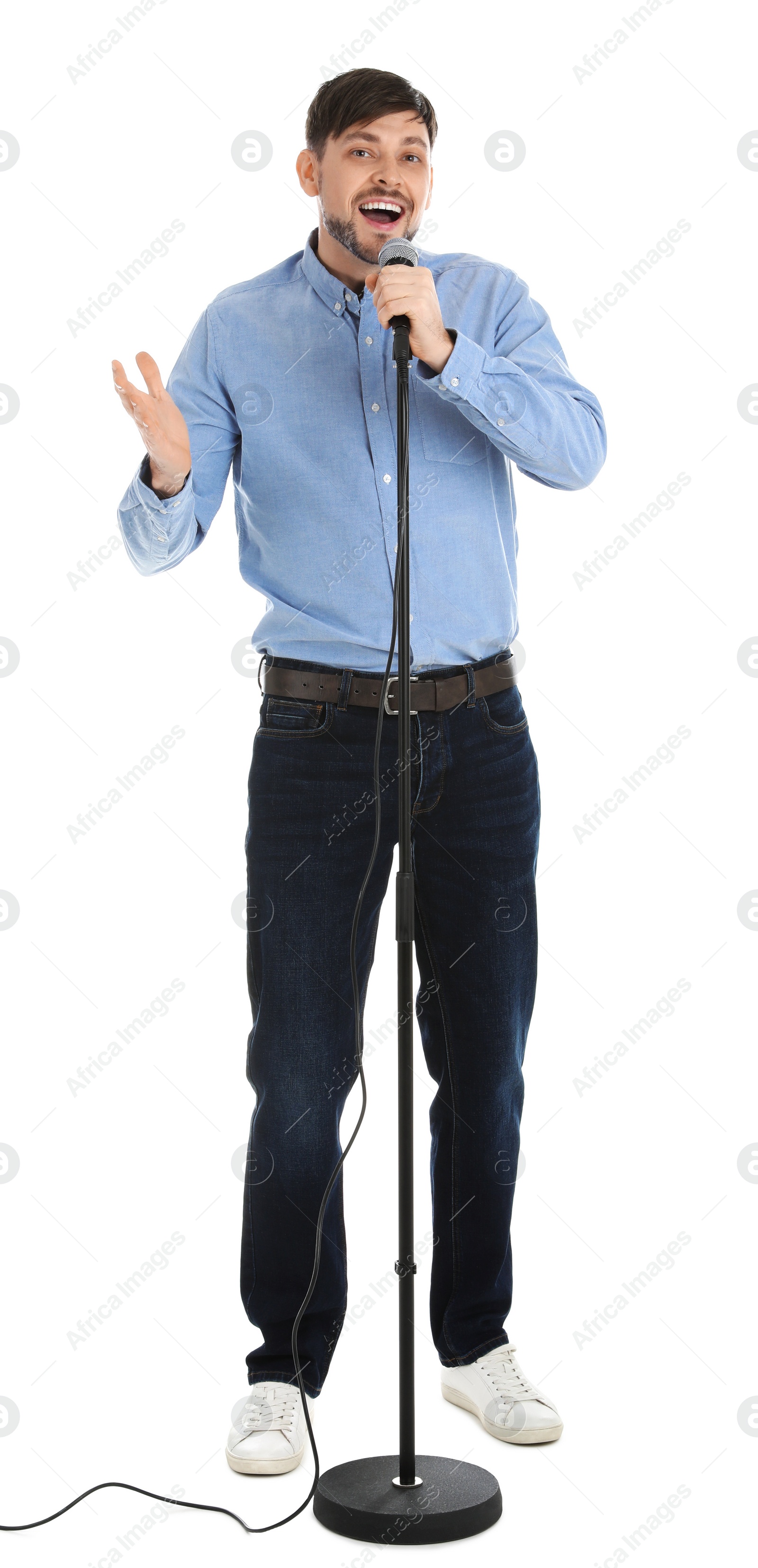 Photo of Handsome man singing in microphone on white background