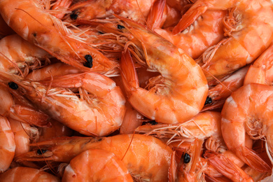 Photo of Pile of delicious cooked shrimps as background, closeup