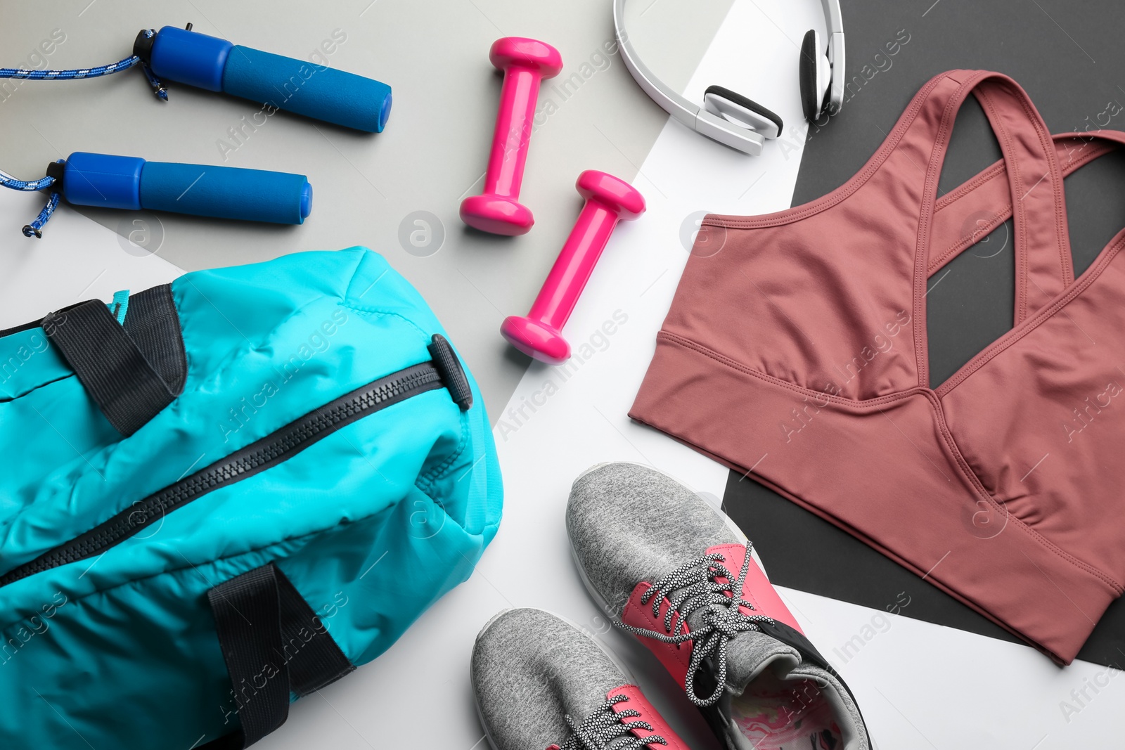 Photo of Flat lay composition with gym bag and sportswear on light grey background