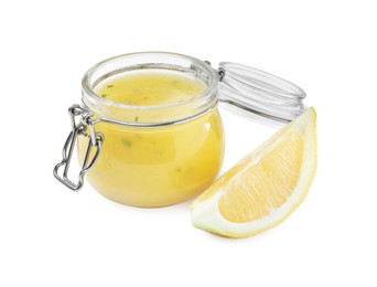 Photo of Jar with lemon sauce on white background. Delicious salad dressing