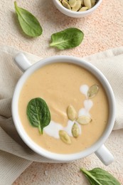 Photo of Healthy cream soup high in vegetable fats on color textured table, flat lay