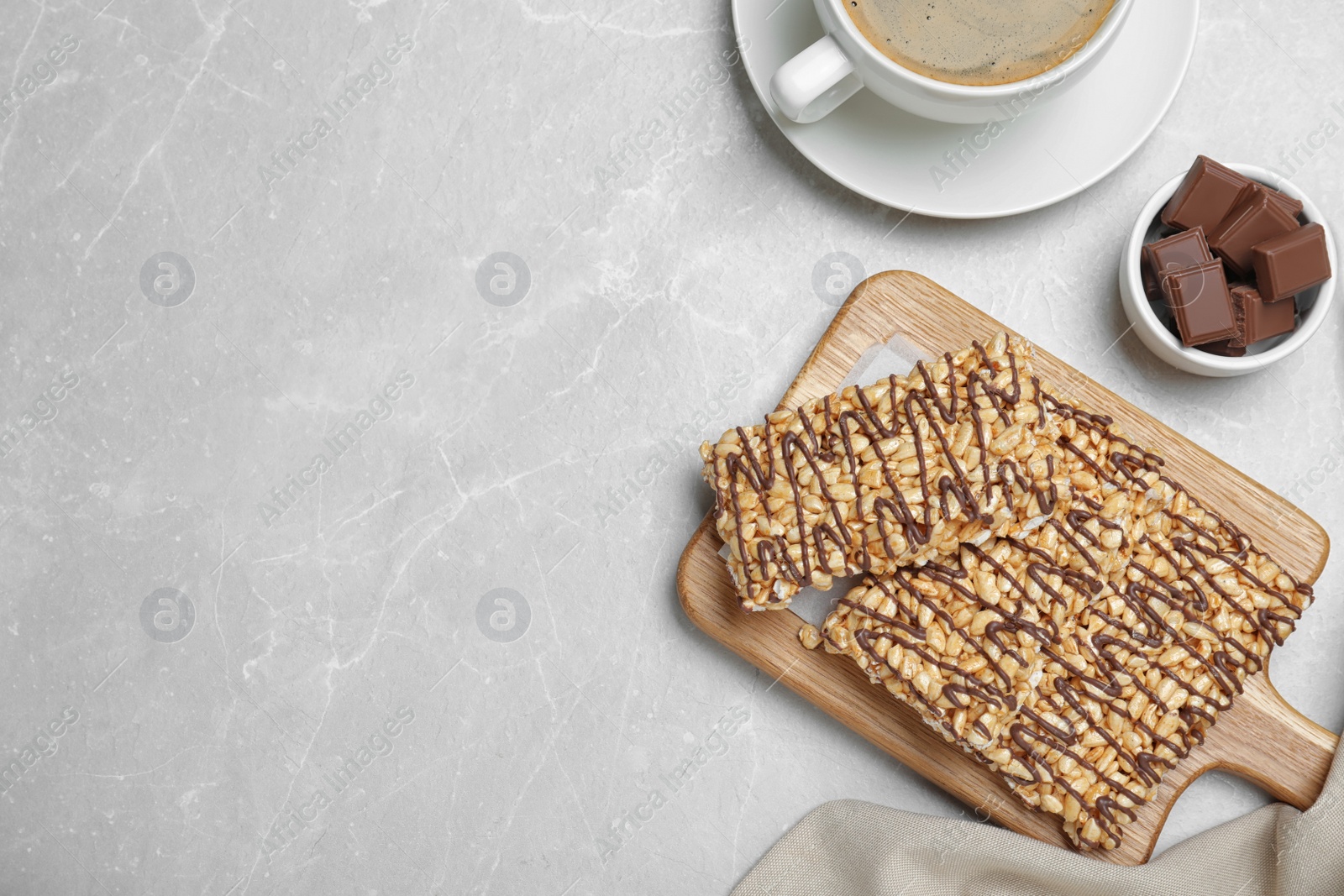 Photo of Delicious rice crispy treats on light grey table, flat lay. Space for text