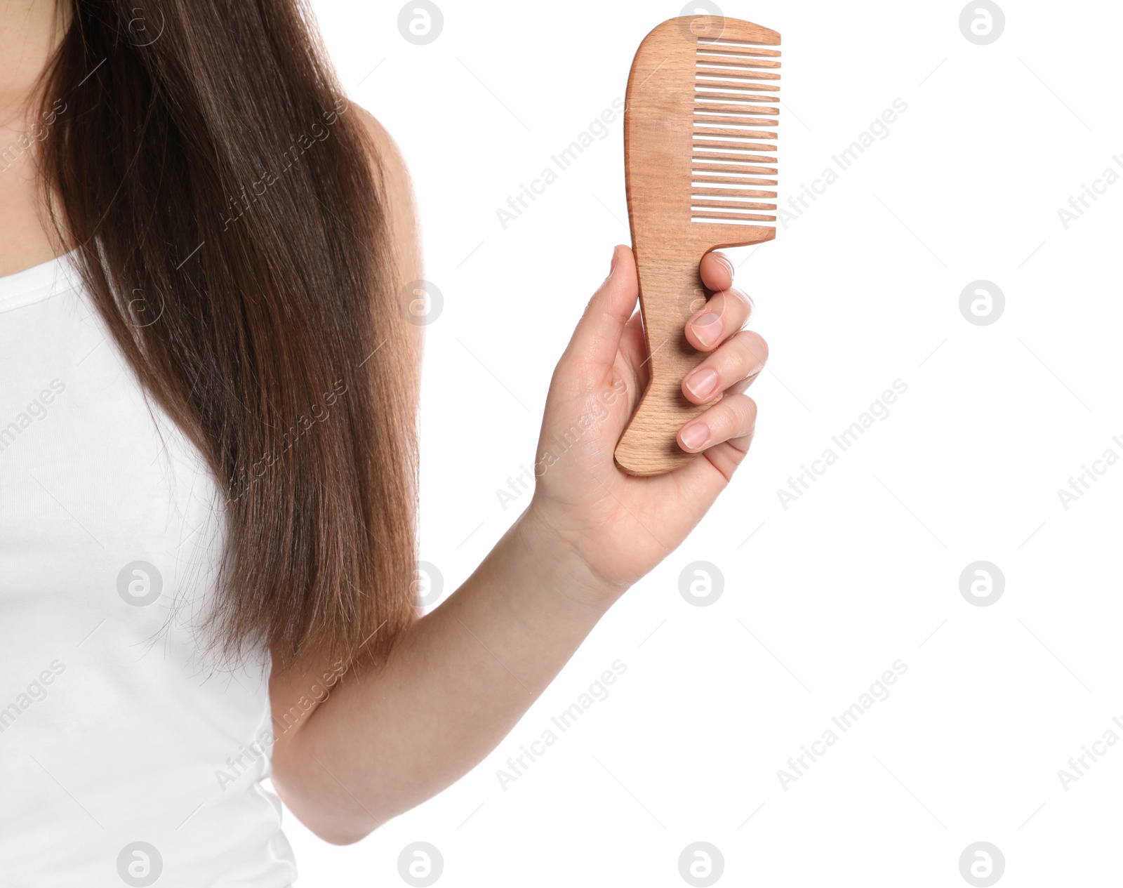 Photo of Woman holding wooden hair comb on white background, closeup