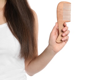 Woman holding wooden hair comb on white background, closeup