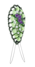 Funeral wreath of plastic flowers against white background